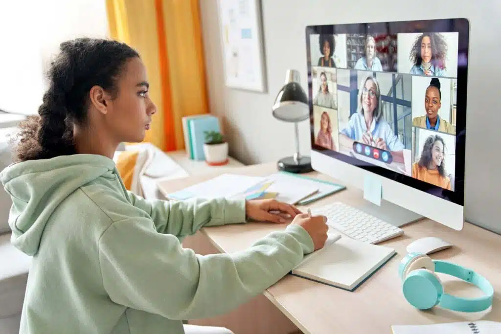 A female college student attending classes virtually on her computer, representing the Gannon University tuition settlement.