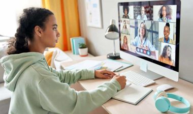 A female college student attending classes virtually on her computer, representing the Gannon University tuition settlement.