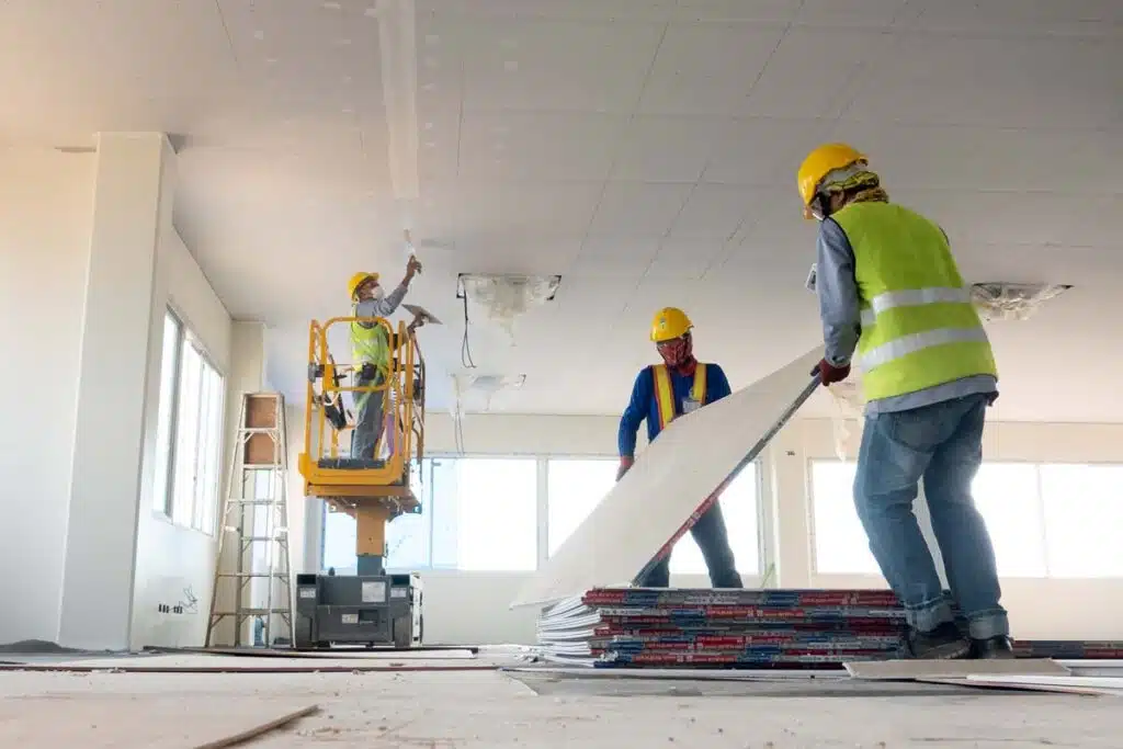 Construction workers installing dry wall, representing the Maryland Applicators settlement.