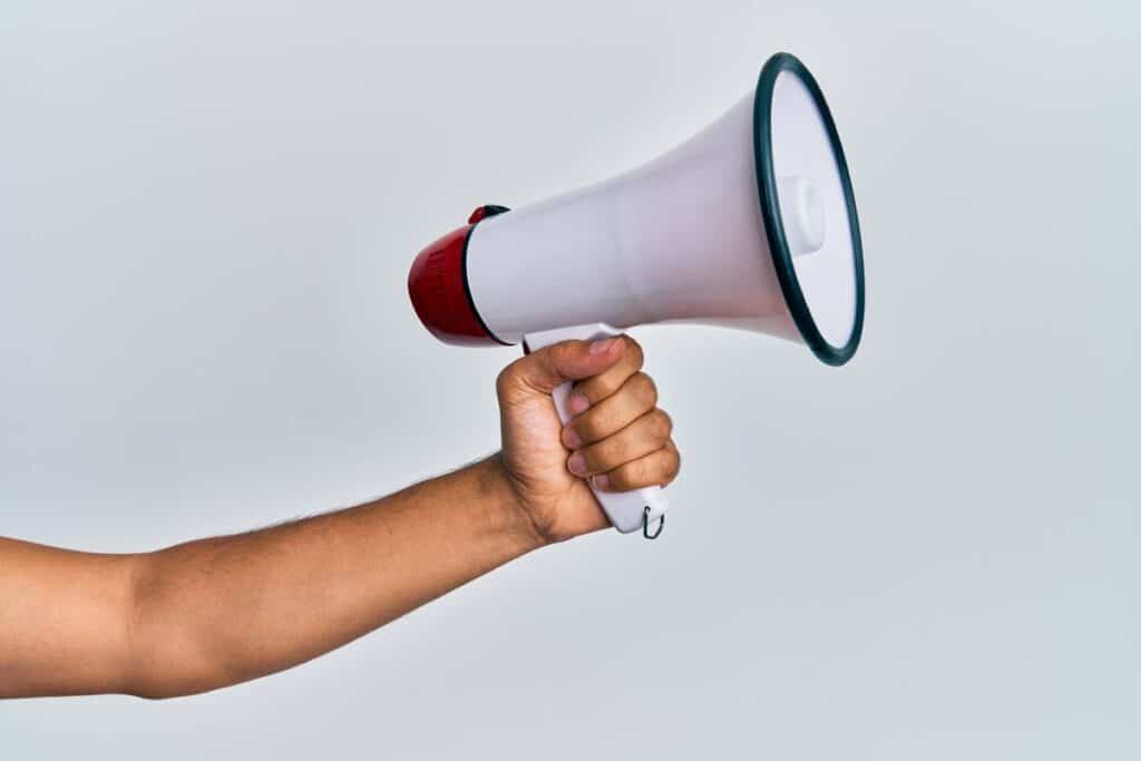 Close up of a hand holding a megaphone, representing top recalls for the week of March 4.