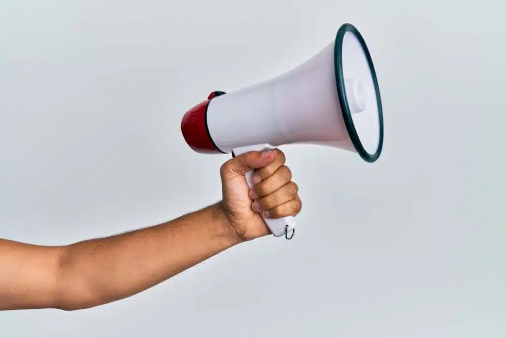 Close up of a hand holding a megaphone, representing top recalls for the week of March 4.