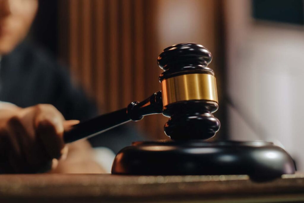 A judge using a gavel in a courtroom, representing PFAS lawsuits.