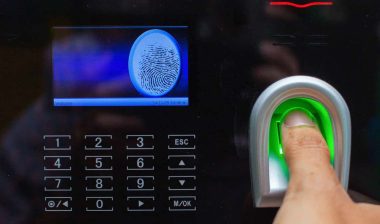Close up of a thumb on a fingerprint scanner on an access control device, representing the BNSF BIPA settlement.