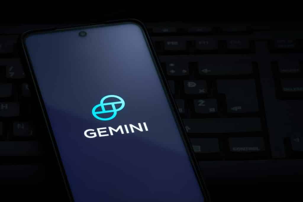 Close up of Gemini logo displayed on a smartphone screen, representing the Gemini fine. Gemini will reimburse losses Gemini Earn users experienced when Genesis Global declared bankruptcy.