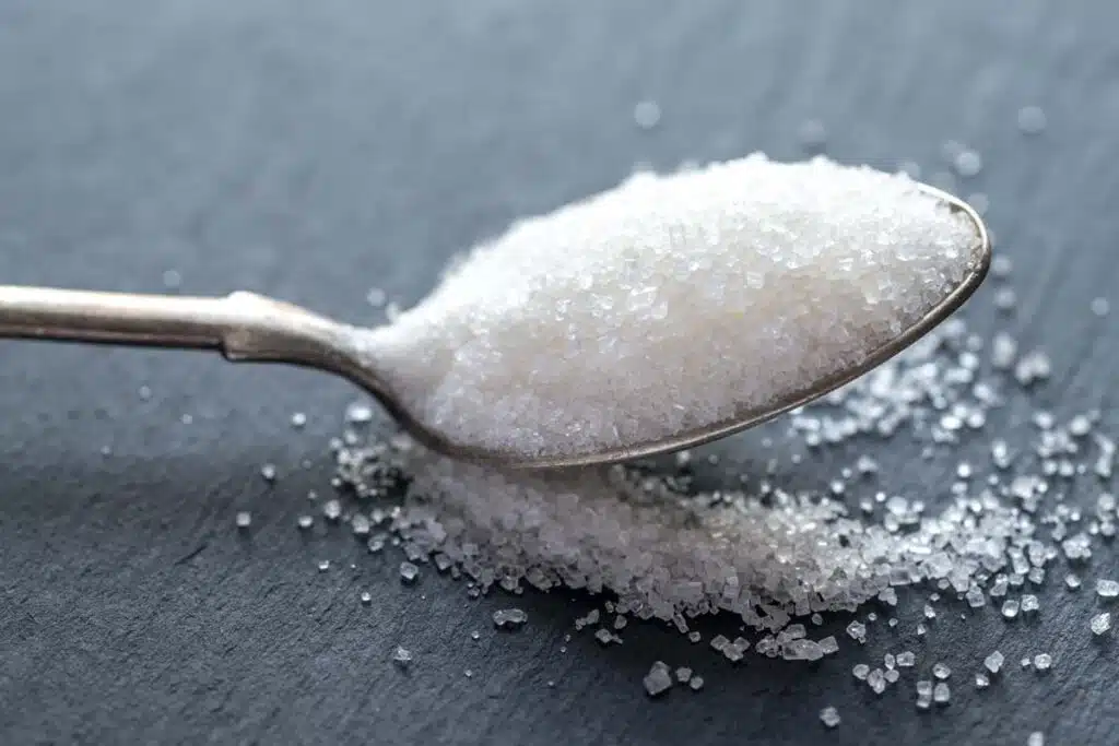 Close up of a spoon of sugar, representing the sugar price-fixing class action.