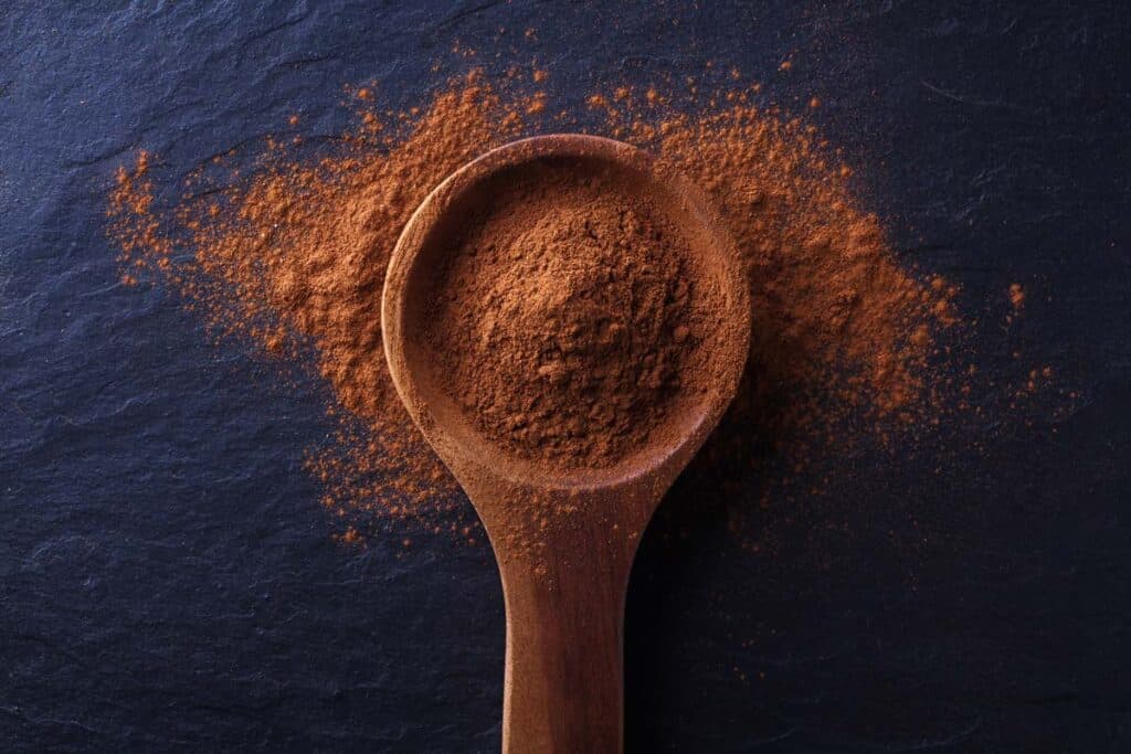 Close up of a wooden spoon filled with cinnamon, representing the cinnamon recalls.