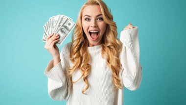 An excited woman holding cash, representing recent settlement checks in the mail.