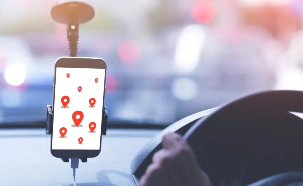 A man is driving public taxi using smart phone go to pointed destination by smart phone.