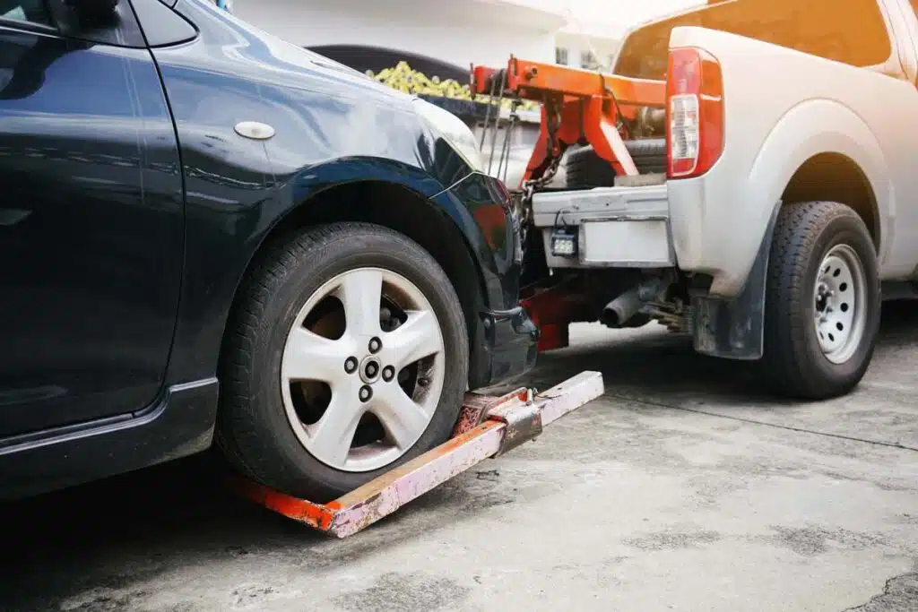 A tow truck repossessing a car, representing the Nicholas Financial debt-collection settlement.