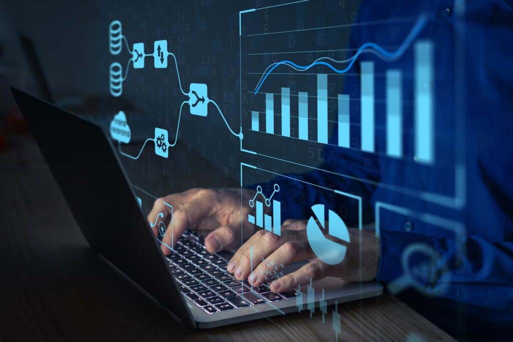 Close up of hands typing on a laptop with a data concept overlay, representing the Convergent Outsourcing data breach settlement.