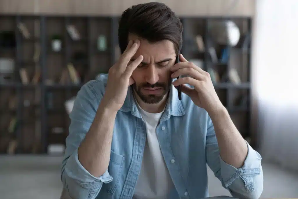 A frustrated man on a phone call, representing the Choice Health TCPA settlement.