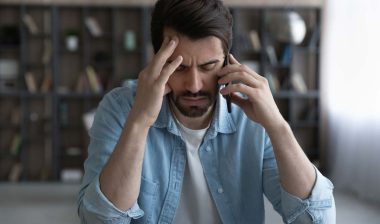 A frustrated man on a phone call, representing the Choice Health TCPA settlement.