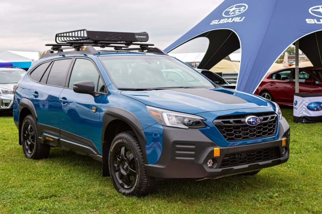A blue 2021 Subaru Outback at a car show, representing the Subaru recall.