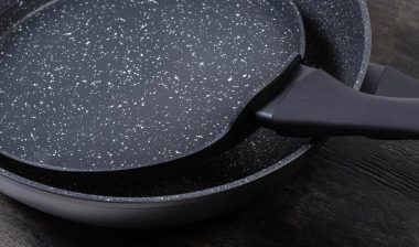 Close up of two frying pans, representing the Brooklyn Steel class action.