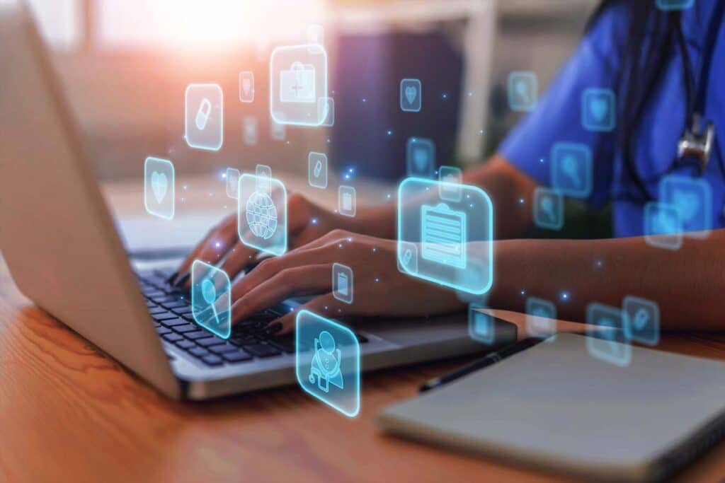Close up of medical professional typing a laptop with a patient data concept overlay, representing the Presbyterian Healthcare Services data breach settlement.