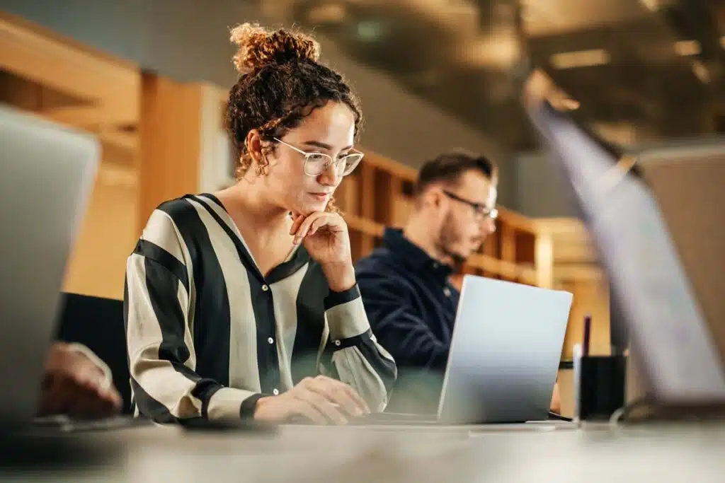 Close up of a woman using a laptop for an online training program, representing the Response Marketing FTC refunds.