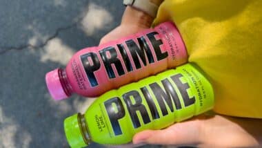 Close up of hands holding Prime Hydration drinks, representing the Prime Hydration class action.