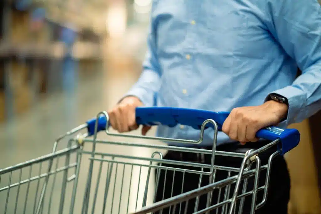 Close up of a man pushing a shopping cart, representing top recalls for the week of April 1.