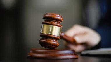 Close up of a judge using a wooden gavel, representing false advertising class actions.