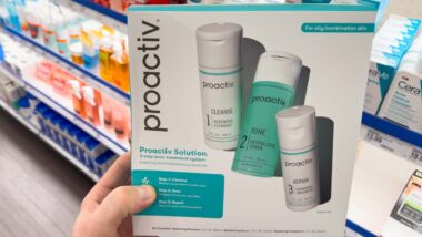 Close up of a woman holding a Proactiv product kit, representing the Proactiv class action.