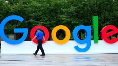 A security guard walking in front of large Google signage, representing Google data class action lawsuit.