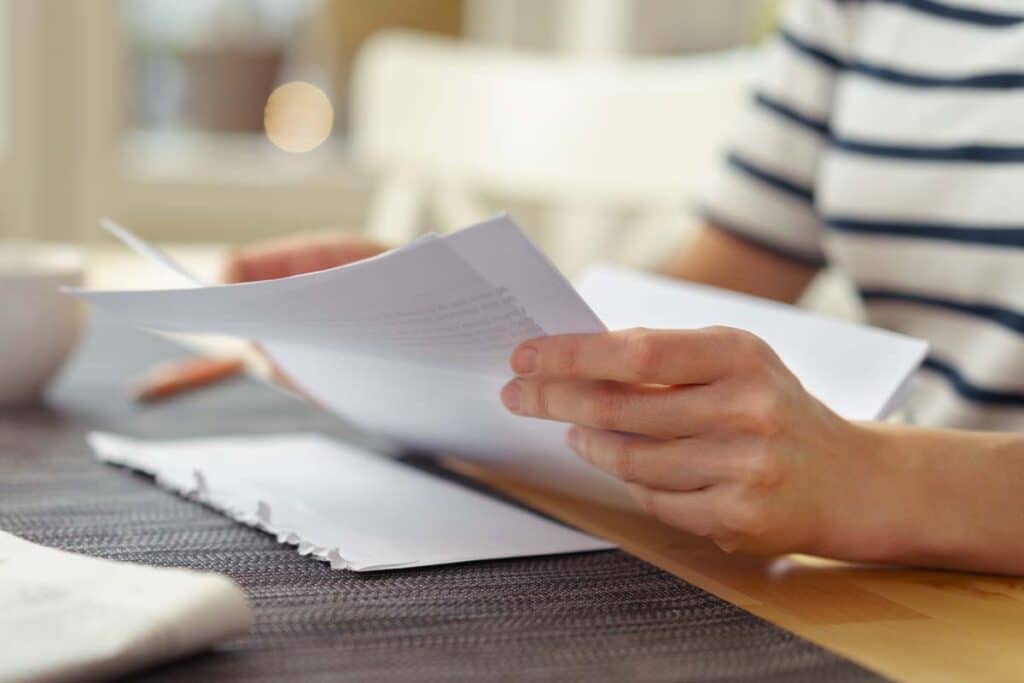 Close up of a woman reading a letter from the HOA, representing the Rizzetta & Co. HOA fees settlement.