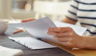 Close up of a woman reading a letter from the HOA, representing the Rizzetta & Co. HOA fees settlement.