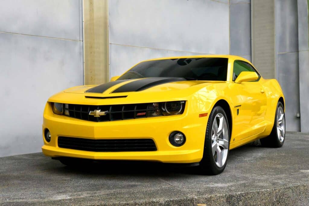 A yellow and black Chevrolet Camaro outdoors, representing the GM class action.