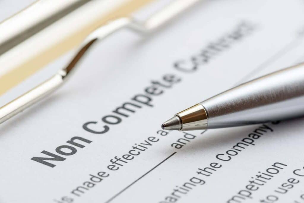 Close up of a pen next to a Non Compete Contract document, representing the noncompete lawsuit.