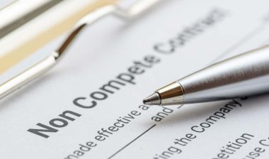 Close up of a pen next to a Non Compete Contract document, representing the noncompete lawsuit.