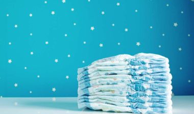 A stack of new diapers in a baby room, representing the Munchkin class action.