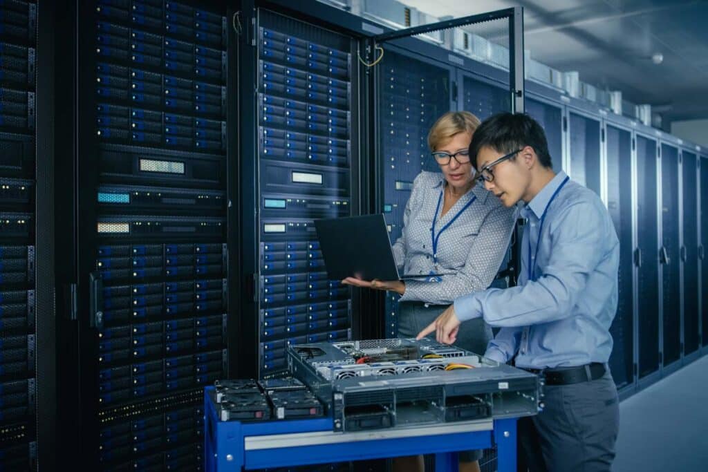 IT workers doing repairs in a server room, representing the Connexin data breach settlement.