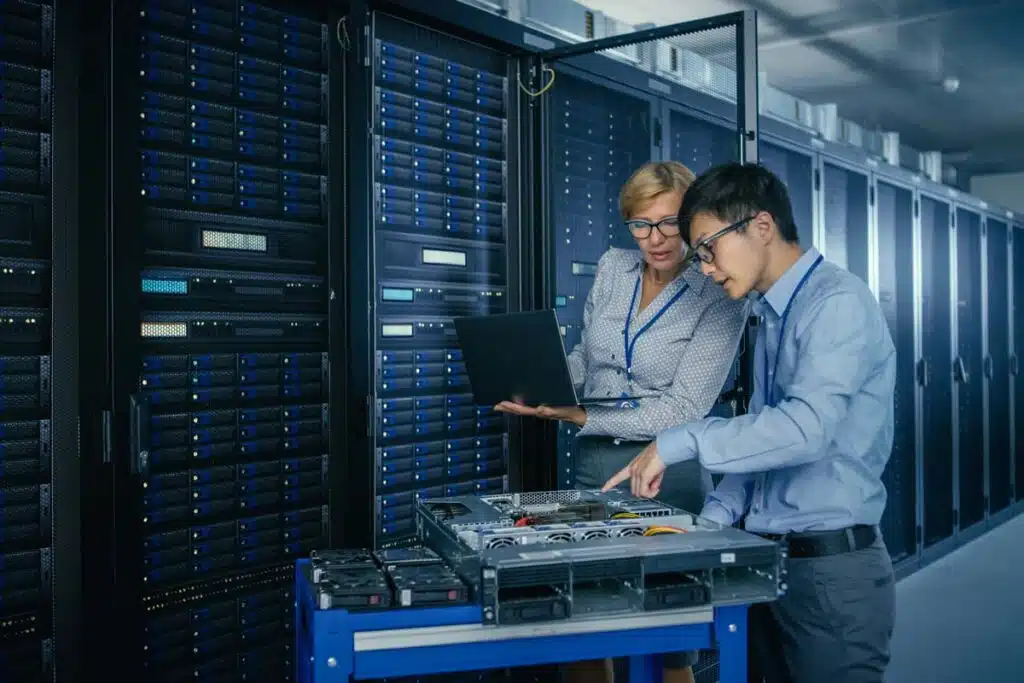 IT workers doing repairs in a server room, representing the Connexin data breach settlement.