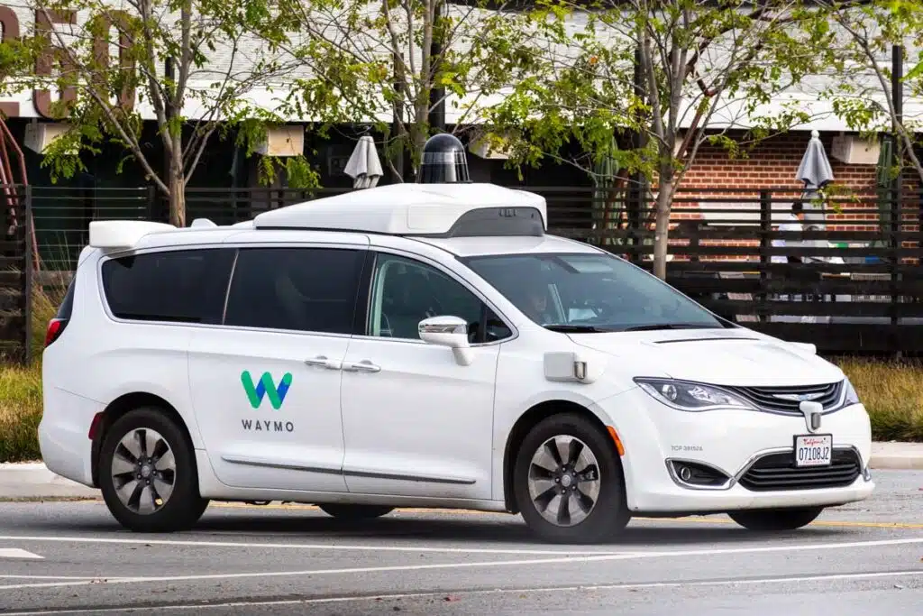 A Waymo car on the road, representing the Waymo and Zoox safety investigations.