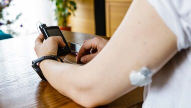 Close up of a woman using an insulin pump, representing the insulin pump app recall.