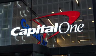 Close up of illuminated Capital One signage at night, representing the Capital One class action.