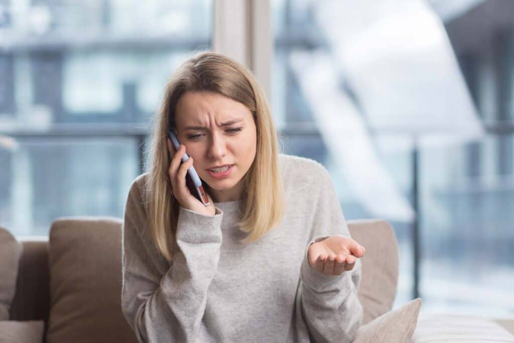 An annoyed woman talking on the phone, representing the Sunpro Solar class action.