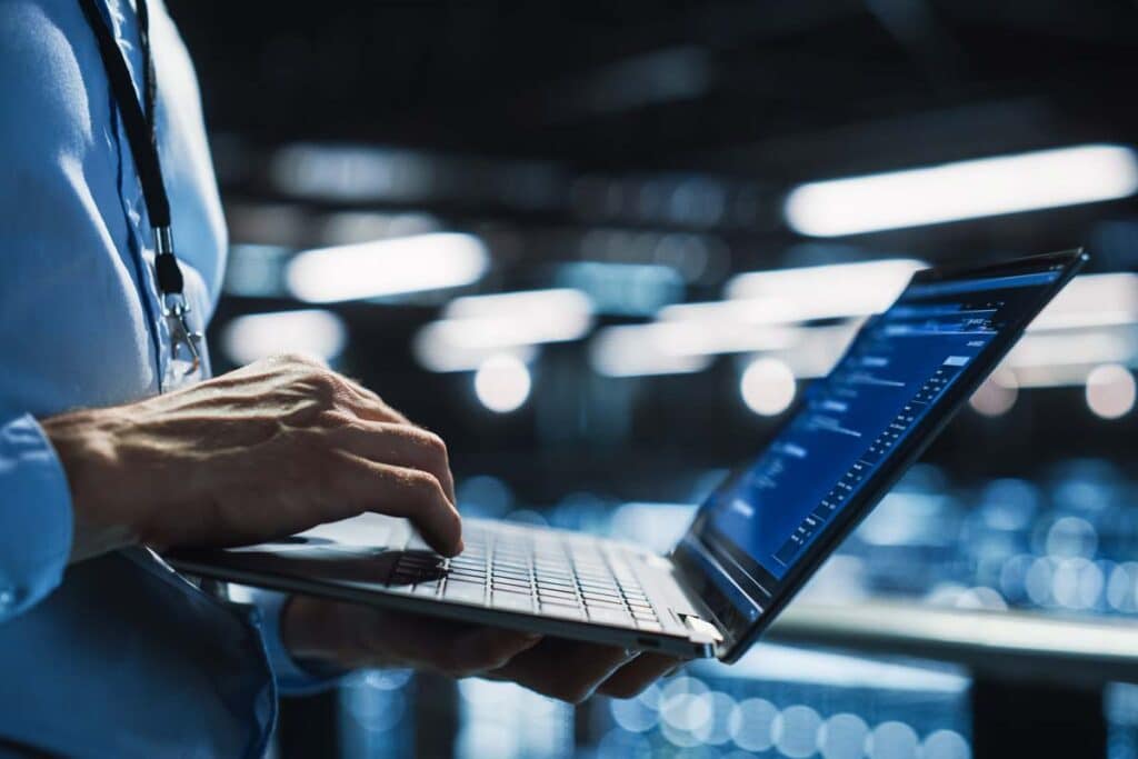 Close up of an IT worker using a laptop, representing the Pacific Guardian class action.
