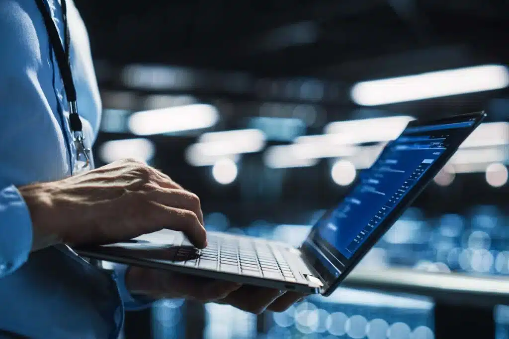 Close up of an IT worker using a laptop, representing the Pacific Guardian class action.