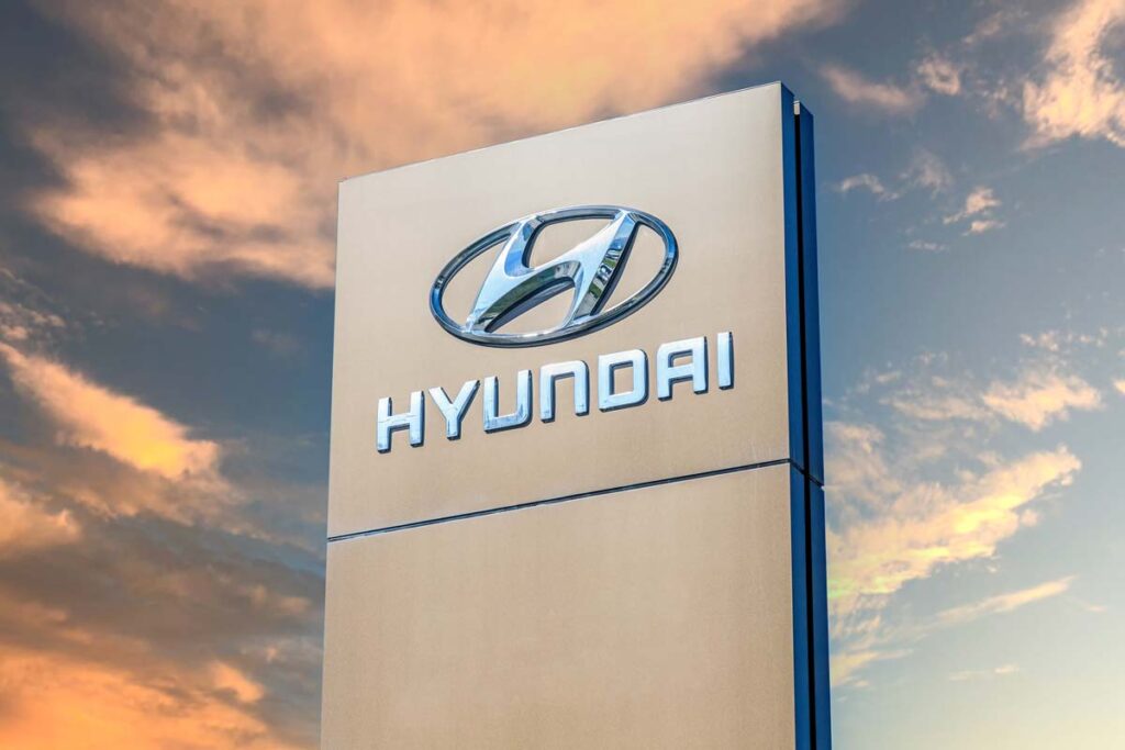 Hyundai signage against a sunset sky, representing the Hyundai settlement.