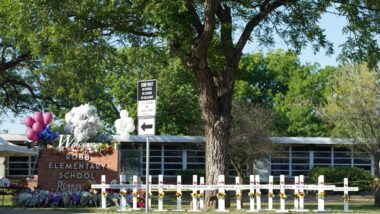 Exterior of Robb Elementary School with a memorial out front, representing the Uvalde lawsuits.