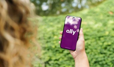 Close up of a woman using a smartphone with the Ally logo displayed, representing the Ally Financial class action.
