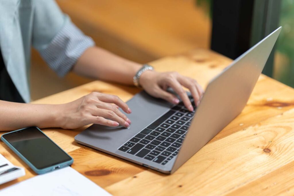 Close up of a woman using a laptop, representing the data tracking class actions.