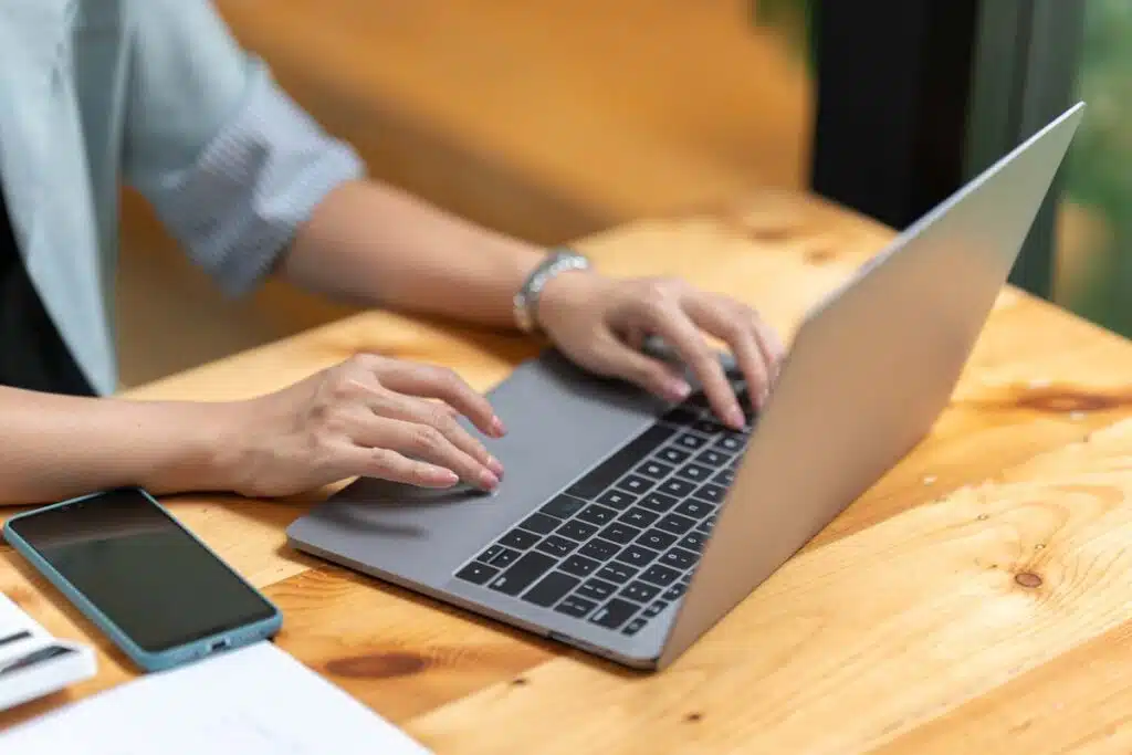Close up of a woman using a laptop, representing the data tracking class actions.