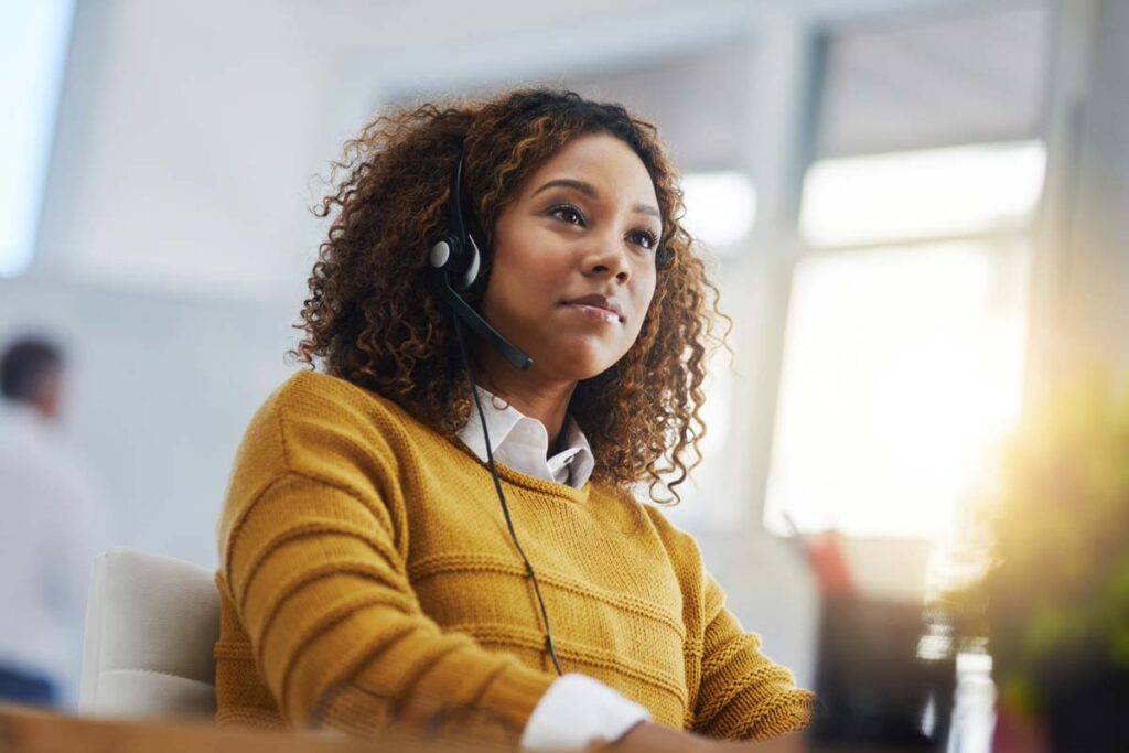 A female agent wearing a headset on a phone call, representing the Stanley Steemer class action.