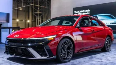 A red Hyundai Elantra on display in a large room, representing the Hyundai recall.