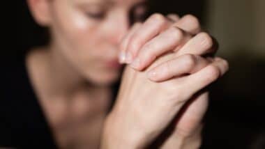 young woman praying Feeling desperate.