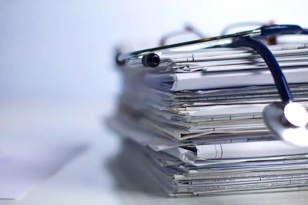 Close up of a stethoscope on top of a stack of medical records, representing the Verisma Systems settlement.