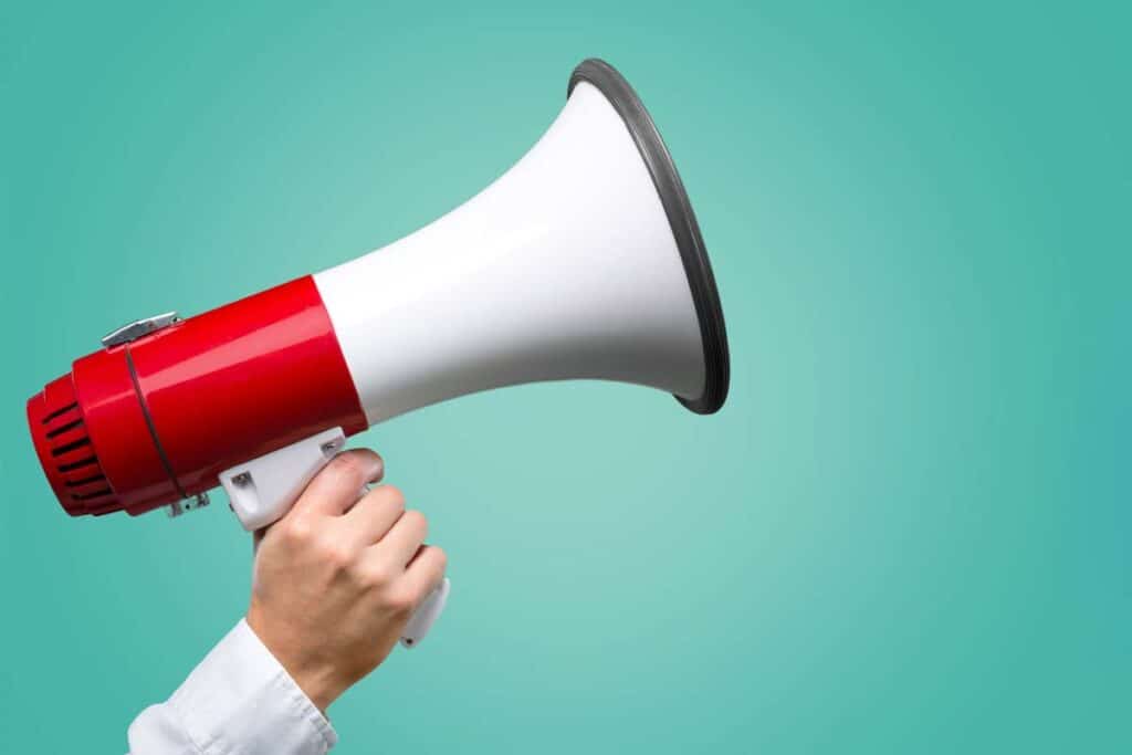Close up of a hand holding a megaphone, representing top recalls for the week of May 20.