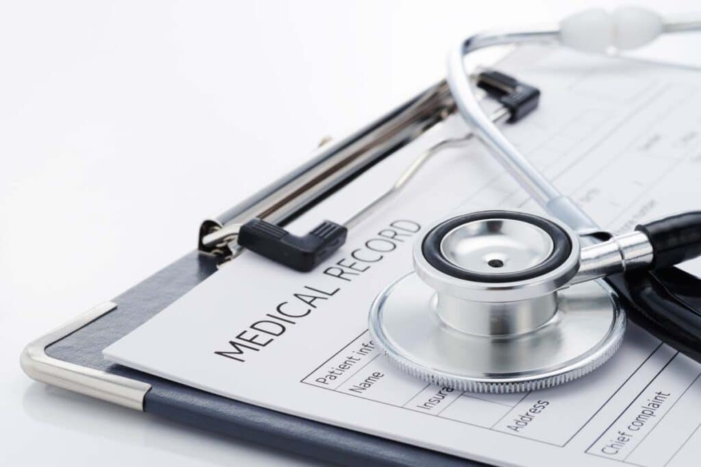 Close up of a medical records form with a stethoscope on top, representing the West Virginia medical record fee settlement.